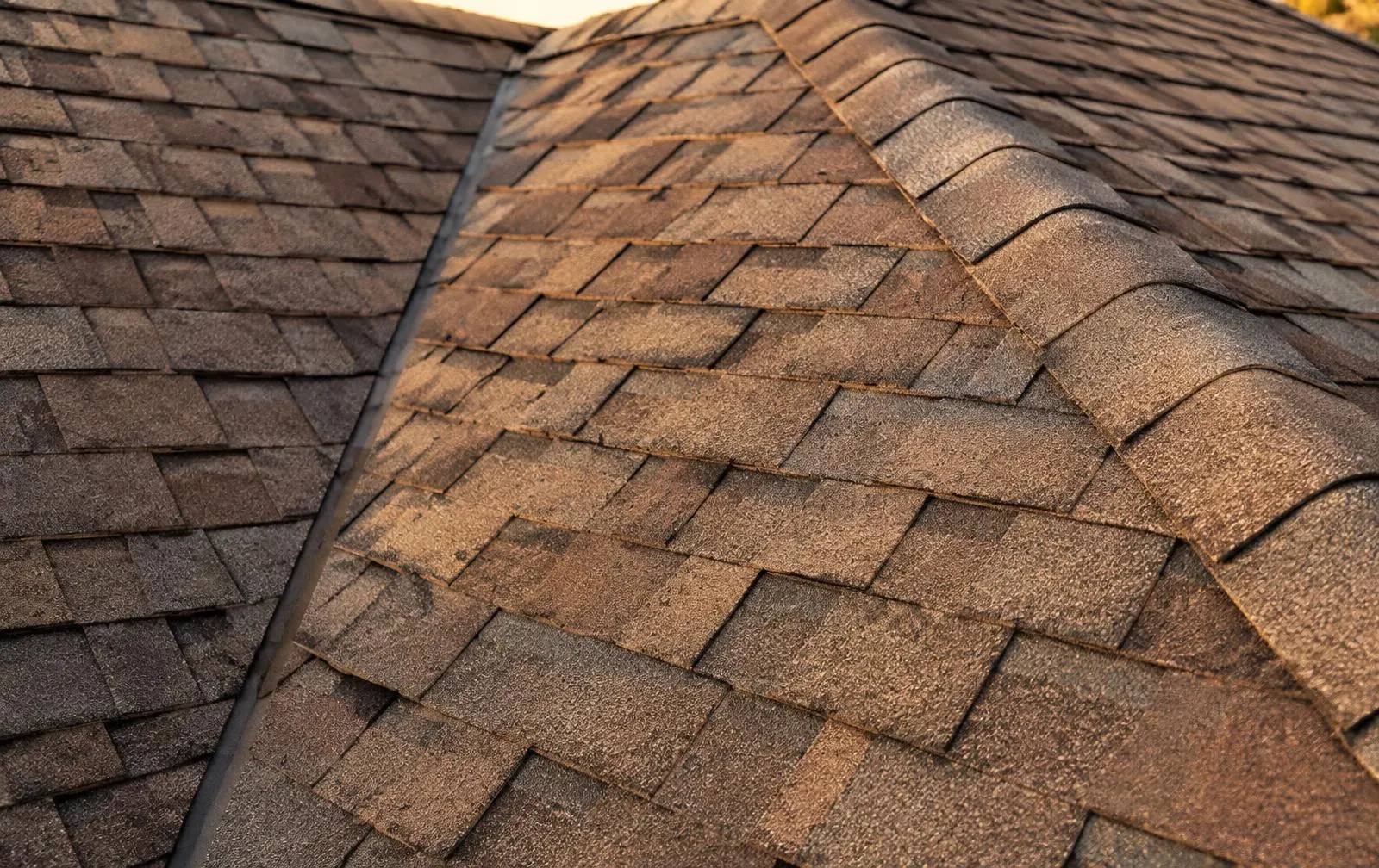 Close-up of new brown architectural shingles on a replaced roof